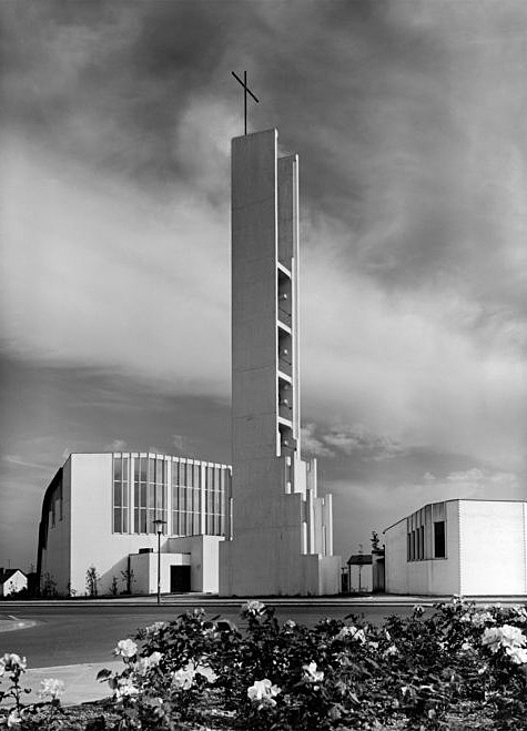 BW photo of a white church with a tall belfry