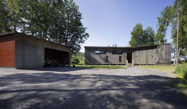 Courtyard with gray low wooden buildings on two sides