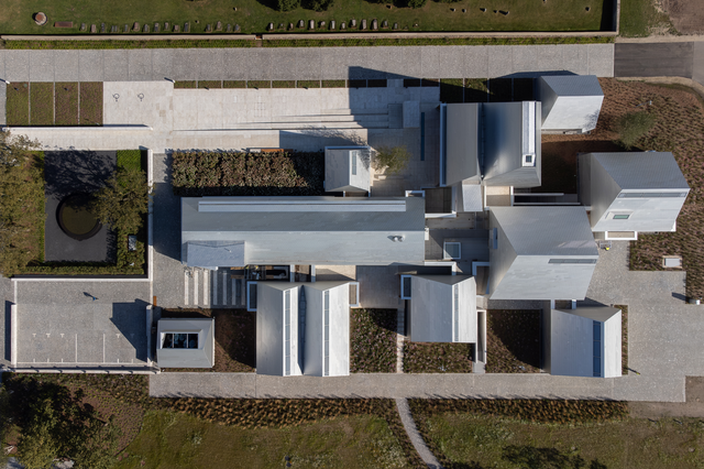 An aerial view of the building complex, featuring aluminium-clad roofs.