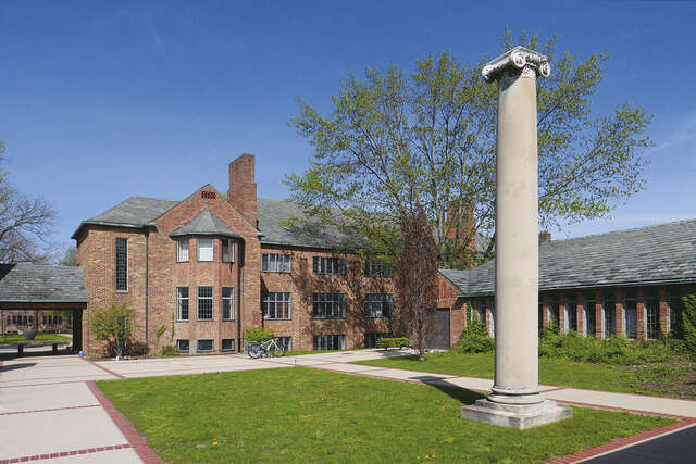 Red brick building, a Roman column in the yard