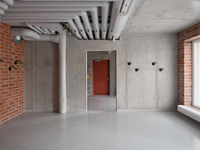 An empty space with wall vents on the ceiling.