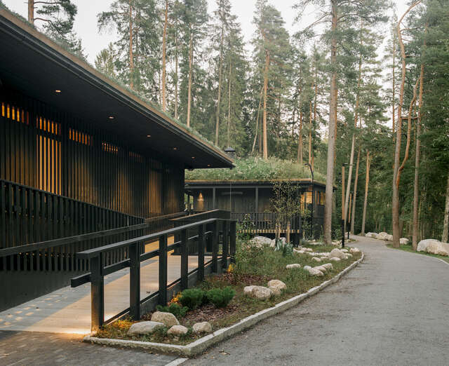 A path on the right and two wooden buildings on the left.