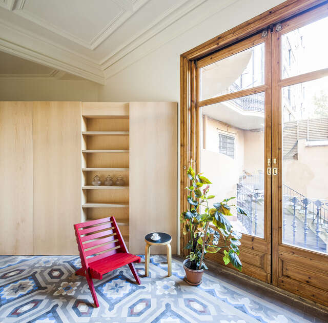 Red chair in front of a large old window