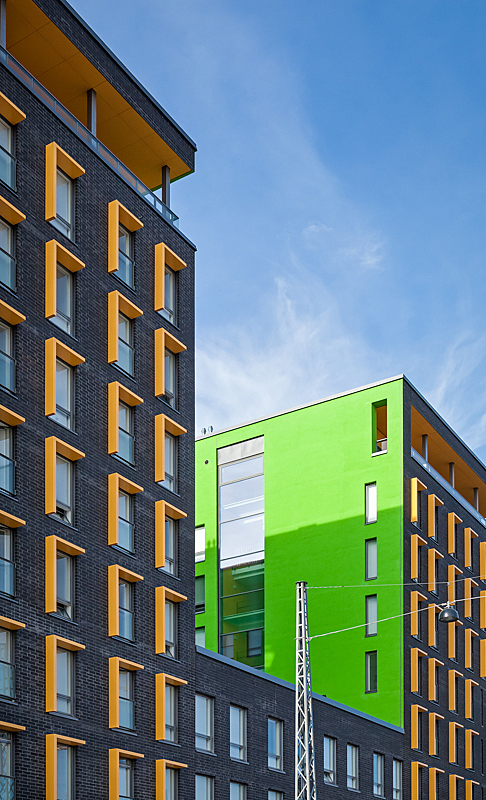 Detail of orange façade elements and bright green inner wall