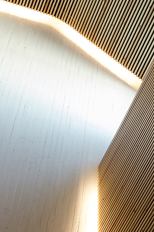 Detail of white and light wooden wall and ceiling elements