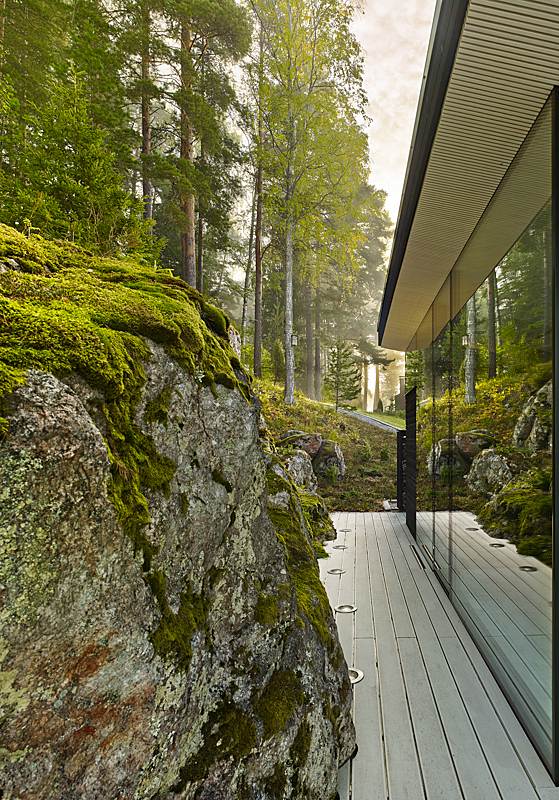 Plank path between rock and glass façade