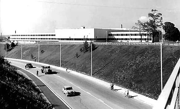 Two-lane road, university building behind it