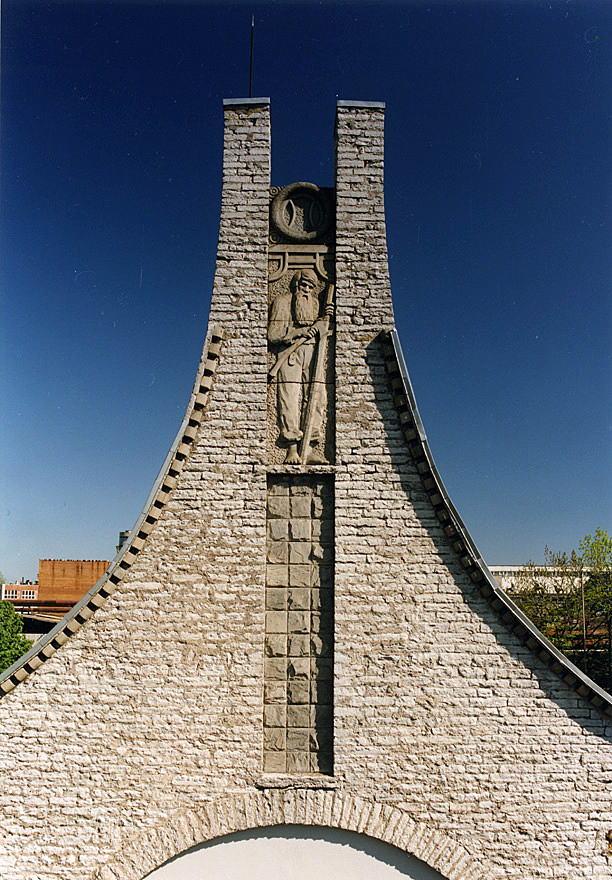 A bearded man is depicted at the highest point of the building.