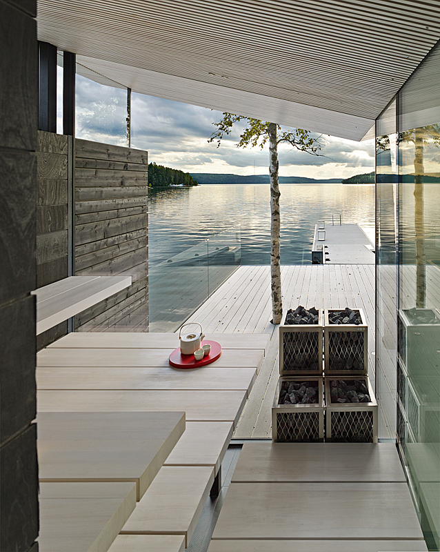 Sauna views under a light-coloured diagonal roof to a dock and sea