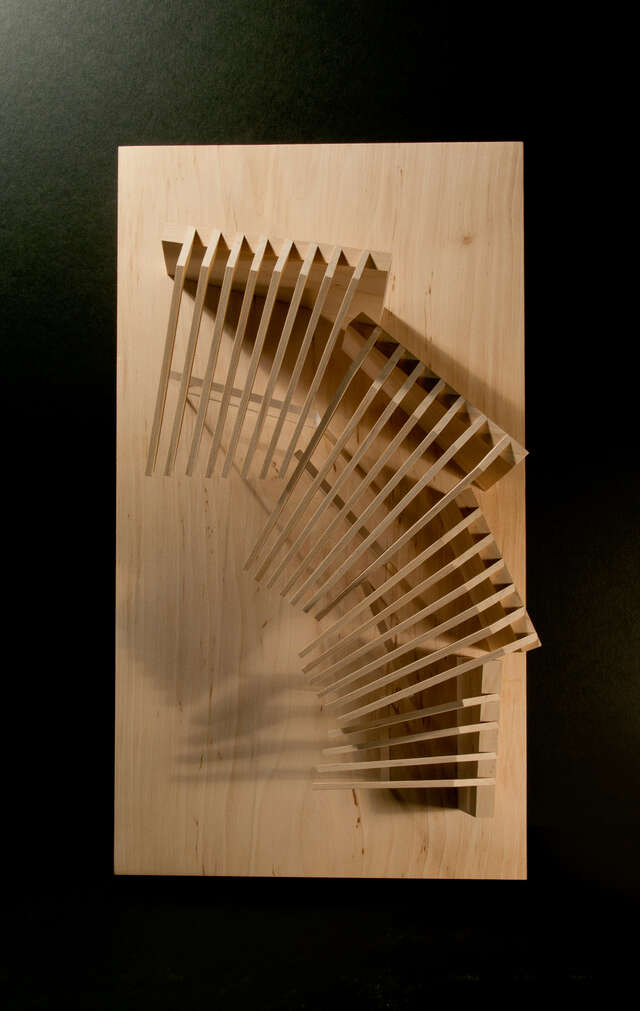 Wooden scale model of a half-moon-shaped villa