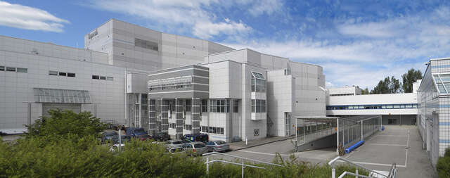 Facade with white and grey tiles.