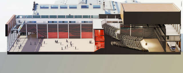 Section picturing the auditorium with seats in two levels and a speaker on a stage