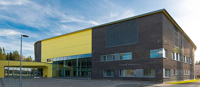 Schoo facade with red-brick and yellow panels.