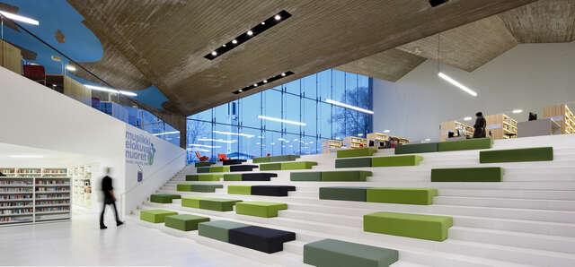 Reading terrace with white steps and green-toned cushions