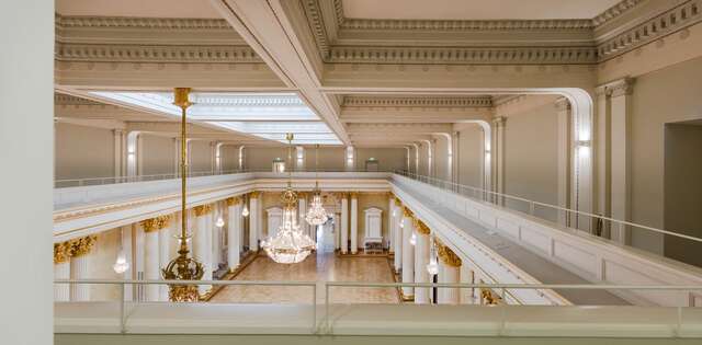 Upper balcony with decorative ceiling elements looking at the ballroom.