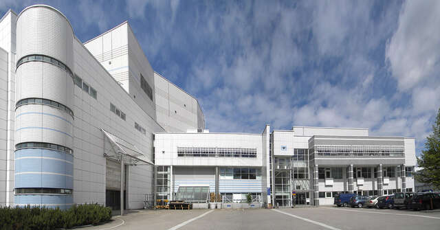 Building facade with white and pale blue ceramic tiles.