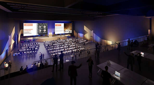 Presentation hall with large seating area and screen in the front.