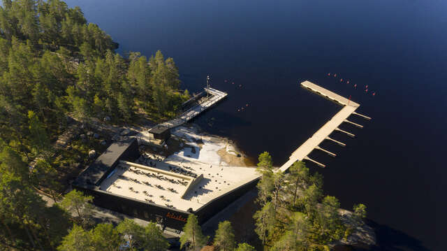 Entire building as seen from above. Water and pier on the right.
