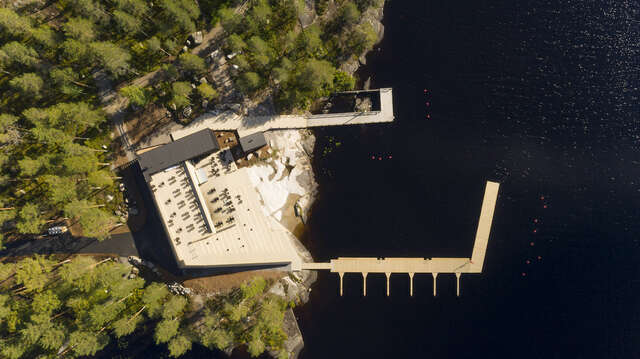 Entire building as seen from above. Water and pier on the right.