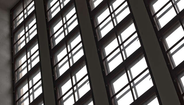 Photo of high, industrial machine hall windows.