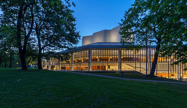 Facade of the Helsinki City Theatre during sunset.