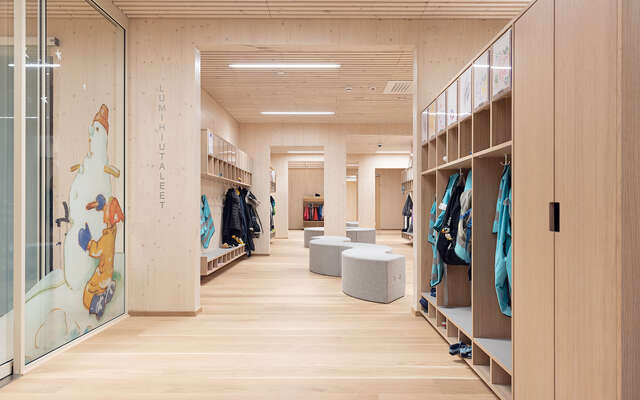 Wooden interior with closets for hanging up clothing. Seating area in the middle.
