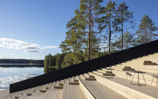 Large wooden staircase with black handrail.