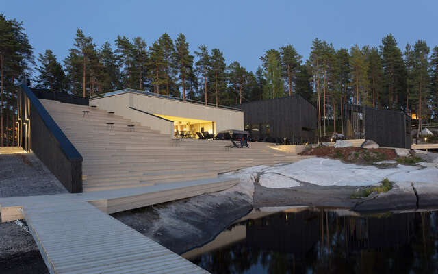 View of the structure as seen from a pier. Large wooden staircase on left.