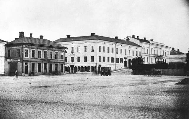 White and brick buildings behind a square.