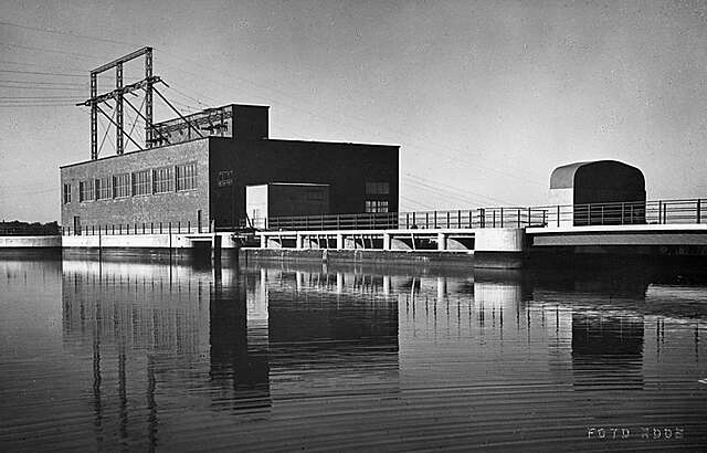 Red-Brick power plant next to water.