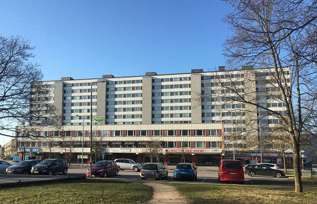 High-rise apartment block of eleven floors and annexe of three floors for commercial premises.