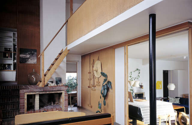 Studio with stairs up, fireplace and opening to the living room