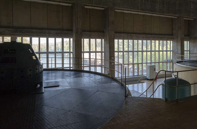 Interior space in the power plant with natural light coming from the straght row of vertical windows in a straight line.