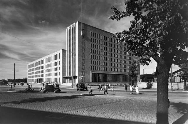 High-rise office building, pedestrians, bicycles and cars from the 1930's