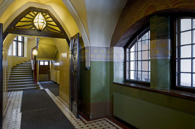 Green and yellow hallway with dark wooden details.