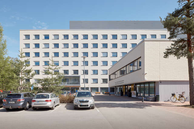 A large white building with multiple rows of square windows.