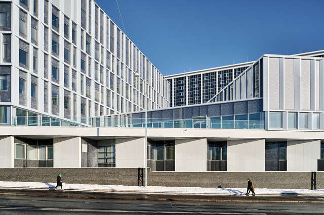A large building seen from the street during wintertime.