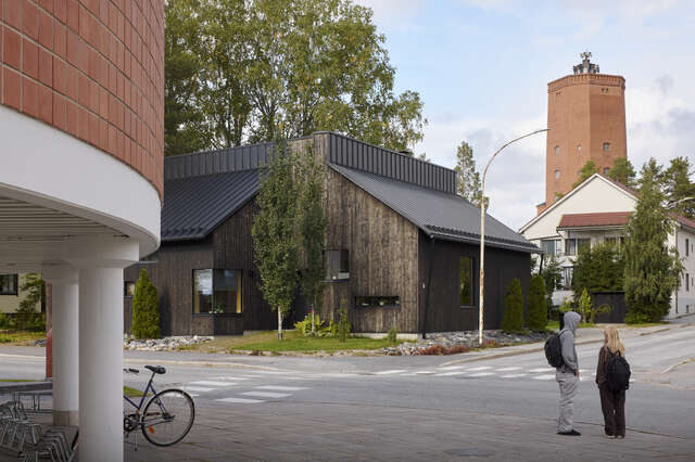 A brown wooden house in an urban area