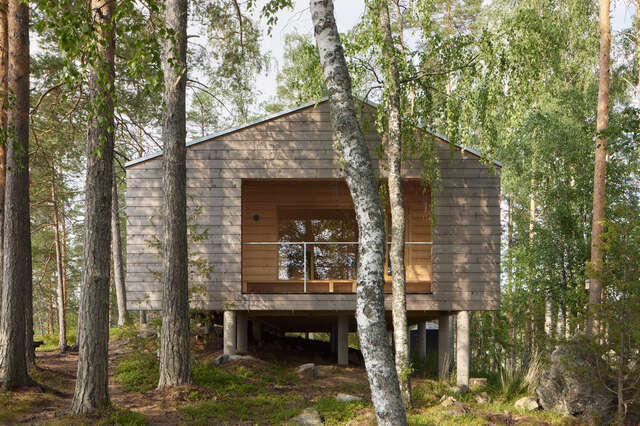 A small wooden cabin in the middle of a forest.