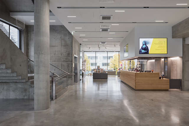 A space inside a concrete building with exhibition cases.