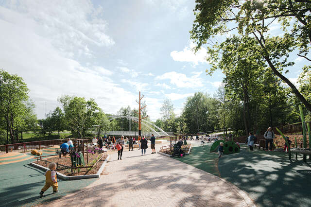 A paved walkway through a park.