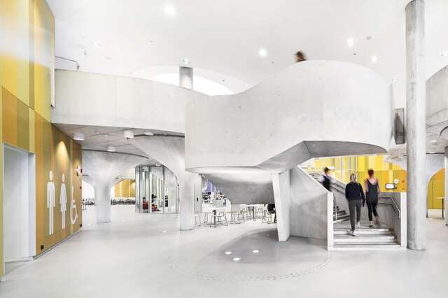 Light concrete staircase with orange walls in the background