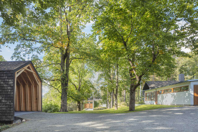 two large trees and scattered small buildings