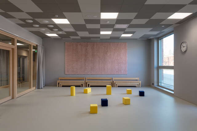 A gray room with colorful blocks on the floor