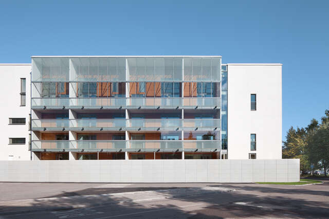 White residential building with wooden terraces