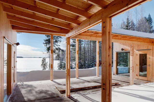 View from central atrium towards the opening snowy landscape with forest