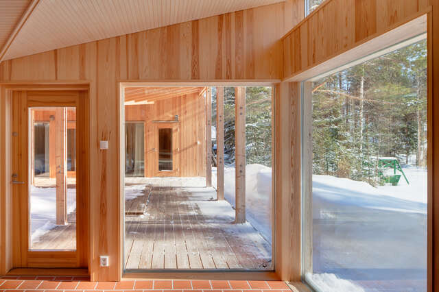 Slanting ceilings and view through high-level windows to the central atrium showing carpentry work in detail