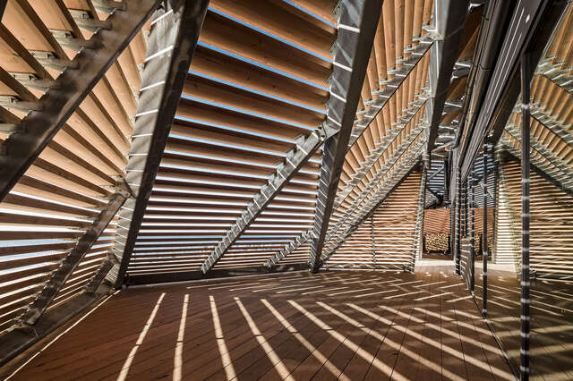 Wooden balcony with wood with planks to keep it private but to be able to see the sea.