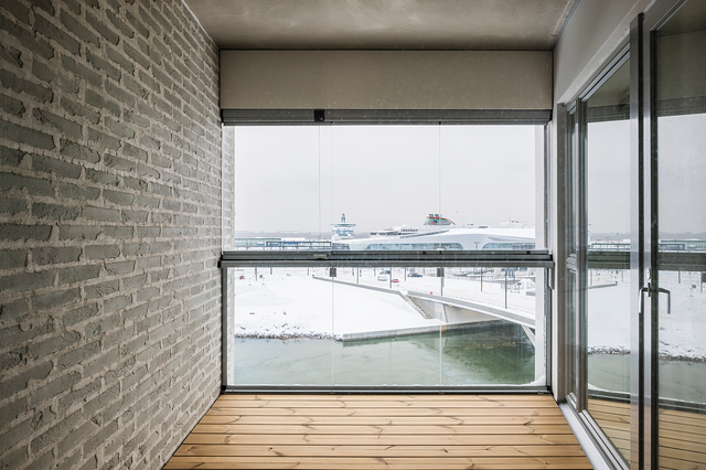 balcony with wood floor, glass walls.