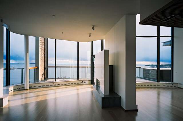 Top floor apartment with window walls towards the sea.
